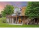 Exterior shot of the home showing the decks, yard, mature trees, and the surrounding landscape at 7883 S Espana Way, Centennial, CO 80016