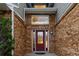 Close up of front door with sidelights and brick facade and well kept landscaping at 7883 S Espana Way, Centennial, CO 80016