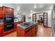 Gourmet kitchen boasts a center island with gas cooktop, double oven, and natural light at 7883 S Espana Way, Centennial, CO 80016