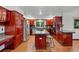 Spacious kitchen features wood cabinetry, a center island, and stainless steel appliances at 7883 S Espana Way, Centennial, CO 80016