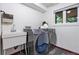 Functional laundry room featuring a sink, modern washer and dryer, and ample natural light from the window at 7883 S Espana Way, Centennial, CO 80016