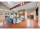 Inviting living room with vaulted ceilings, brick fireplace, and sliding glass doors to a balcony at 7883 S Espana Way, Centennial, CO 80016