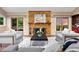 Cozy living room featuring a brick fireplace and sliding doors leading to an outdoor deck at 7883 S Espana Way, Centennial, CO 80016