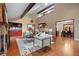 Open-concept living area with a fireplace, hardwood floors, and access to the dining room at 7883 S Espana Way, Centennial, CO 80016