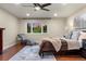 Comfortable main bedroom featuring hardwood floors, ceiling fan, and a beautiful view of the outdoors at 7883 S Espana Way, Centennial, CO 80016