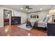 Spacious main bedroom with hardwood floors, fireplace, ceiling fan and a sunlit window with outdoor views at 7883 S Espana Way, Centennial, CO 80016