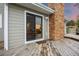 Back patio features a sliding glass door, brick chimney, and wooden deck, offering a relaxing outdoor space at 7883 S Espana Way, Centennial, CO 80016