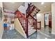 Bright foyer showcasing a beautiful staircase with dark wood and marble floors at 7883 S Espana Way, Centennial, CO 80016