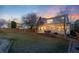 Exterior of the home at dusk with string lights illuminating the patio and expansive green backyard at 9144 Roadrunner St, Highlands Ranch, CO 80129