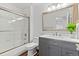 Updated bathroom featuring a glass enclosed tub-shower combo and modern vanity at 9144 Roadrunner St, Highlands Ranch, CO 80129