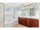 Bright bathroom boasting a soaking tub beneath an arch window and a double sink vanity at 9144 Roadrunner St, Highlands Ranch, CO 80129