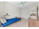 Small bedroom with carpet, a twin bed, large window and modern ceiling fan at 9144 Roadrunner St, Highlands Ranch, CO 80129