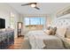 Bright bedroom featuring wood floors, a ceiling fan, and a large window with scenic outdoor views at 9144 Roadrunner St, Highlands Ranch, CO 80129
