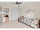 Bright bedroom with a modern ceiling fan, twin bed and sliding door closet at 9144 Roadrunner St, Highlands Ranch, CO 80129