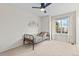 Bright bedroom with a modern ceiling fan, twin bed and a large window at 9144 Roadrunner St, Highlands Ranch, CO 80129
