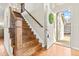Bright entryway featuring hardwood floors and a staircase, leading to upper level of the home at 9144 Roadrunner St, Highlands Ranch, CO 80129