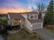 Charming two-story home featuring a well-manicured lawn and a two-car garage, perfect for Gathering living at 9144 Roadrunner St, Highlands Ranch, CO 80129