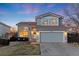 Charming two-story home boasts a well-kept lawn and two-car garage, perfect for comfortable Gathering living at 9144 Roadrunner St, Highlands Ranch, CO 80129