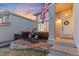 Charming front porch with rocking chairs and an American flag, creating a welcoming entrance at 9144 Roadrunner St, Highlands Ranch, CO 80129