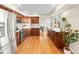 Spacious kitchen featuring stainless steel appliances, wooden cabinets, tile backsplash and lots of light at 9144 Roadrunner St, Highlands Ranch, CO 80129
