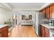 Open kitchen featuring an island with seating that opens to a cozy fireplace and living area at 9144 Roadrunner St, Highlands Ranch, CO 80129