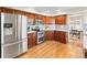 A modern kitchen with stainless steel appliances, rich wood cabinetry and decorative backsplash at 9144 Roadrunner St, Highlands Ranch, CO 80129