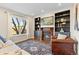 Comfortable living room with fireplace, built-in shelving, a plush sofa and accent chair at 9144 Roadrunner St, Highlands Ranch, CO 80129