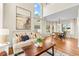Spacious living room with hardwood floors, large windows, and an adjacent dining area, great for entertaining at 9144 Roadrunner St, Highlands Ranch, CO 80129