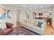 Inviting living room with hardwood floors, large sofa, accent chair, and an adjacent open kitchen at 9144 Roadrunner St, Highlands Ranch, CO 80129