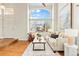 Inviting living room with hardwood floors, large windows, and stylish decor, ideal for Gathering gatherings at 9144 Roadrunner St, Highlands Ranch, CO 80129