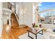 Open-concept living room featuring hardwood floors, high ceilings, and abundant natural light at 9144 Roadrunner St, Highlands Ranch, CO 80129