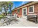 Backyard patio with an outdoor cooking and dining area, perfect for enjoying summer evenings at 8660 De Soto St, Denver, CO 80229