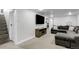 Finished basement area with a large television, comfy seating and carpeted floor at 8660 De Soto St, Denver, CO 80229