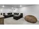 Finished basement area with large sectional, small window, carpeted floor and neutral walls at 8660 De Soto St, Denver, CO 80229