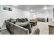Spacious finished basement with a large sectional sofa and comfortable seating, perfect for relaxation and entertainment at 8660 De Soto St, Denver, CO 80229
