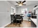 Cozy dining area with a wood table and chairs, illuminated by a stylish ceiling fan at 8660 De Soto St, Denver, CO 80229