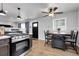 Well-lit eat-in kitchen featuring a wood table, stainless steel range, and modern finishes at 8660 De Soto St, Denver, CO 80229