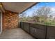 Brick-walled balcony with dark metal railing offers neighborhood views at 1350 Josephine St # 208, Denver, CO 80206