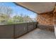 View of the metal-railed balcony with brick accents and string lights at 1350 Josephine St # 208, Denver, CO 80206