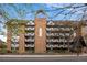 Exterior view of the brick apartment building with balconies and Tudor accents at 1350 Josephine St # 208, Denver, CO 80206