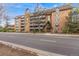 Exterior view of the brick apartment building with Tudor-style accents at 1350 Josephine St # 208, Denver, CO 80206