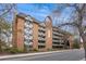 Charming brick condo building with balconies and Tudor-style accents, offering a unique and inviting curb appeal at 1350 Josephine St # 208, Denver, CO 80206