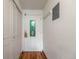 Condo entryway featuring hardwood floors, a stained glass door, and ample closet space for organized living at 1350 Josephine St # 208, Denver, CO 80206