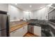 Updated kitchen with white cabinets, wood and black countertops, and stainless steel appliances at 1350 Josephine St # 208, Denver, CO 80206