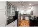 Modern kitchen with stainless steel appliances, white cabinetry, and updated countertops and backsplash at 1350 Josephine St # 208, Denver, CO 80206