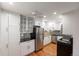 Fully equipped kitchen features stainless steel appliances and modern lighting at 1350 Josephine St # 208, Denver, CO 80206