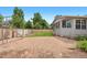 A well maintained backyard featuring a play area with slide and mulched area, green grass and wooden fence at 381 Mountain Cloud Cir, Highlands Ranch, CO 80126