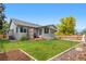 Backyard featuring a deck, well-maintained lawn, and fence offering a private outdoor space for relaxation at 381 Mountain Cloud Cir, Highlands Ranch, CO 80126