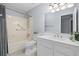Bathroom featuring a tub shower, white vanity, modern fixtures, and light blue walls at 381 Mountain Cloud Cir, Highlands Ranch, CO 80126