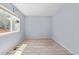 Bright bedroom with light blue walls, wood-look flooring, and a window at 381 Mountain Cloud Cir, Highlands Ranch, CO 80126